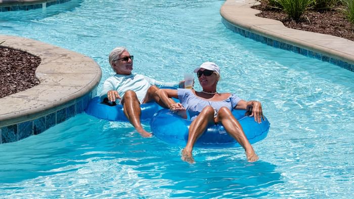 A couple celebrates Labor Day Weekend as they float along the lazy river at Camp Creek Inn