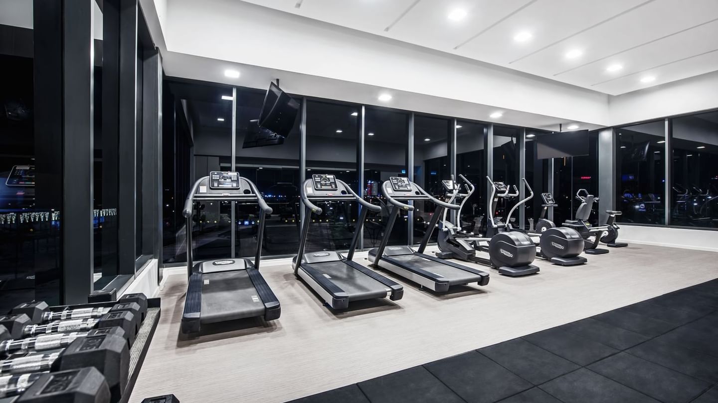 Interior view of a gym showcasing treadmills aligned against mirrors at Sunway Hotel Big Box