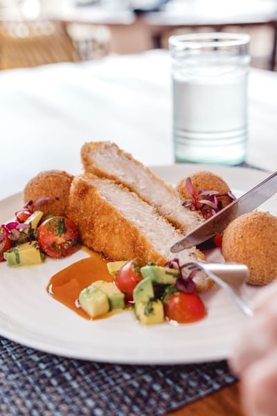 Close-up of Chicken drumsticks and mini kieve balls dish served in La Playa Restaurant at Amaka Ocean Living Lodge