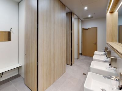 Shared bathroom with sinks, toilets and showers at UniLodge Herston.