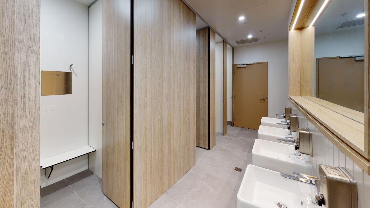 Shared bathroom with sinks, toilets and showers at UniLodge Herston.