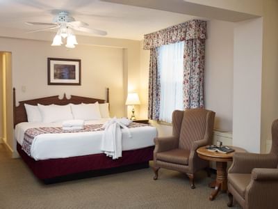 King bed with two reading chairs.