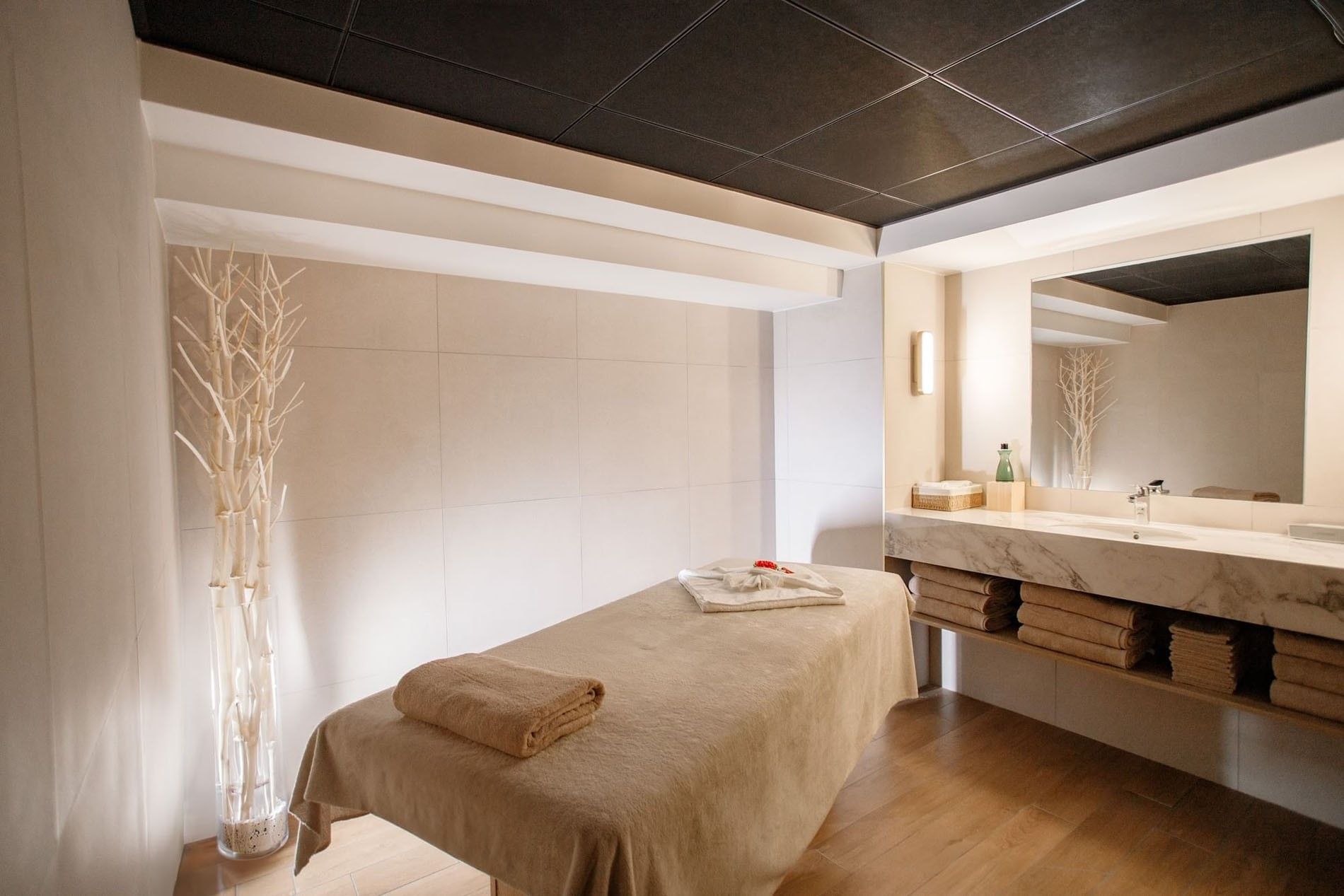 Luxury wood-paneled sauna with tiered seating and ambient lighting at Warwick Reine Astrid - Lyon