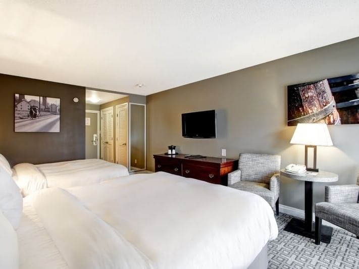 bedroom with 2 queen size bed & TV at The Inn of Waterloo