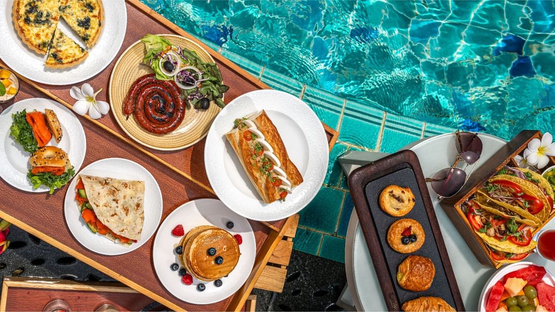Breakfast dishes served by a shimmering poolside at Sunway Hotels & Resorts