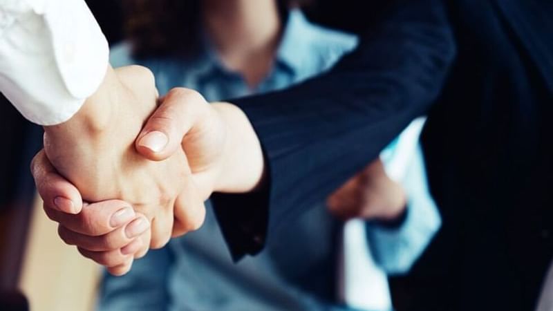 Close-up of a handshake in a meeting room at Fiesta Inn