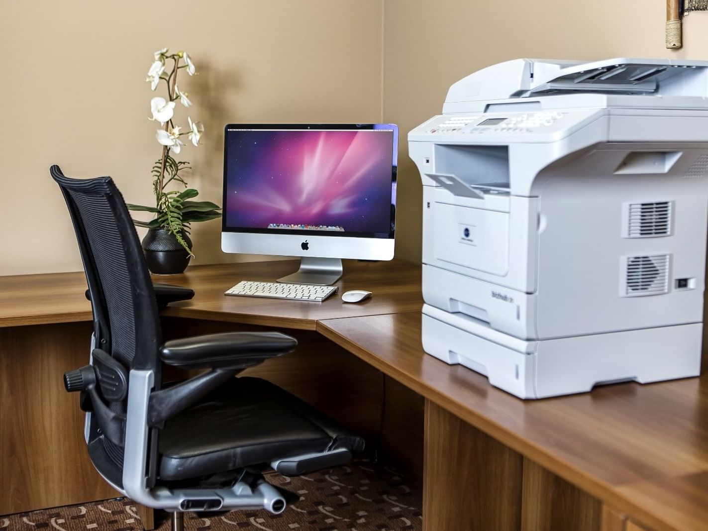 Business workspace with an iMac and a printer at Metterra Hotel on Whyte