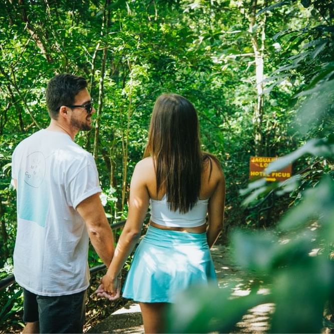 Couple holding hand & walking near Ficus Lodge