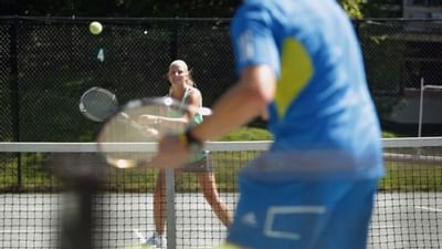 Two people playing tennis at Topnotch Stowe Resort