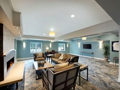 Modern lounge area in Aspire Residences at The Stanley Hotel with a fireplace comfortable seating and a large patterned rug