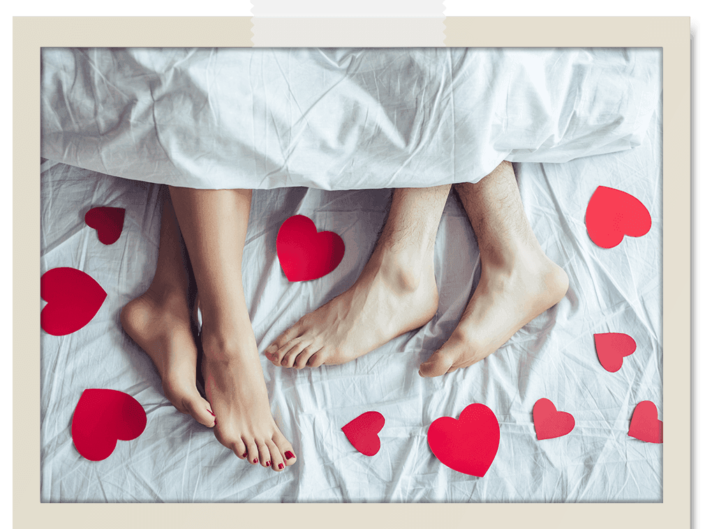 Bristol Boutique Hotel Campbell - Romantic Getaway - couple with feet sticking out from under the covers and heart cutouts