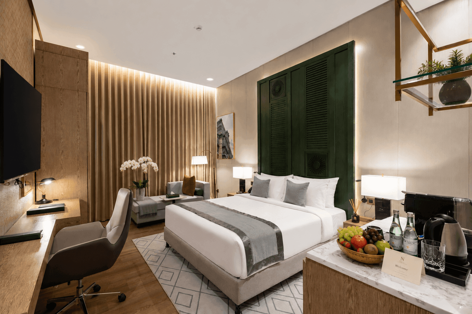 Table near bed beside daybed in Deluxe Room at Naviti by Warwick Jeddah, capturing stylish hotel rooms in Jeddah