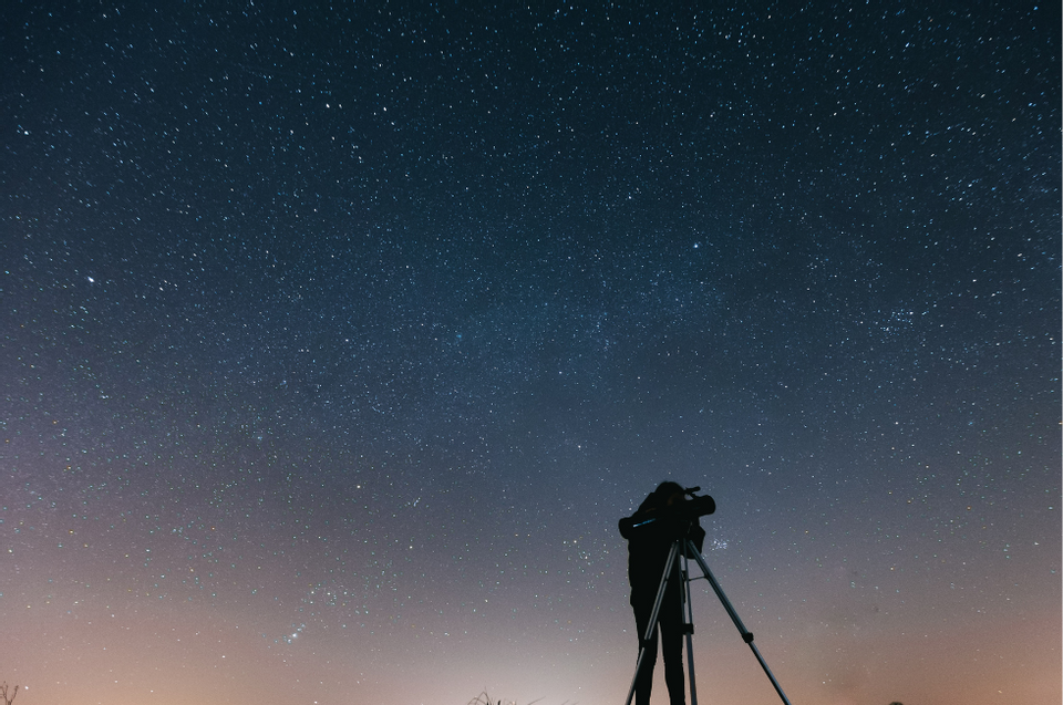Man stargazing in the night sky near Amora Hotel Sydney