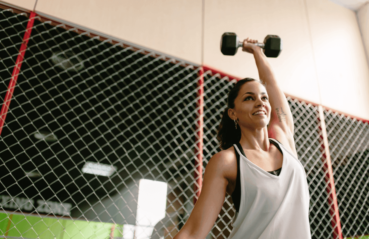 Person lifting a dumbbell at Fitness Room in Starling Hotel Lausanne