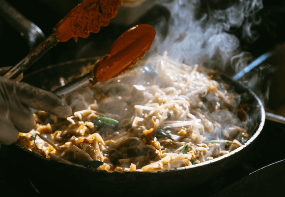 Chef preparing a sizzling dish at Richmond Hill Hotel