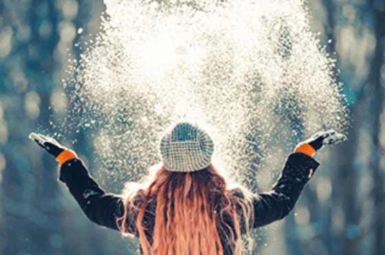 A lady playing snow near The Centennial Hotel during winter