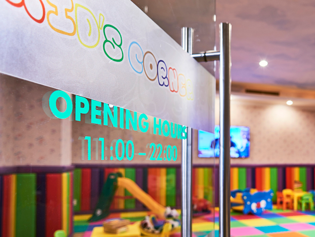 glass door entrance to hotel kids corner with colourful play area