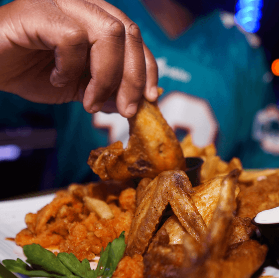 A man having roasted chicken at Clevelander South Beach