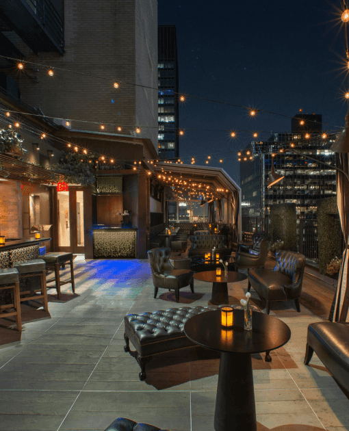 Elegant rooftop lounge with leather chairs at Upstairs at The Kimberly Hotel, highlighting the best hotel in New York City 