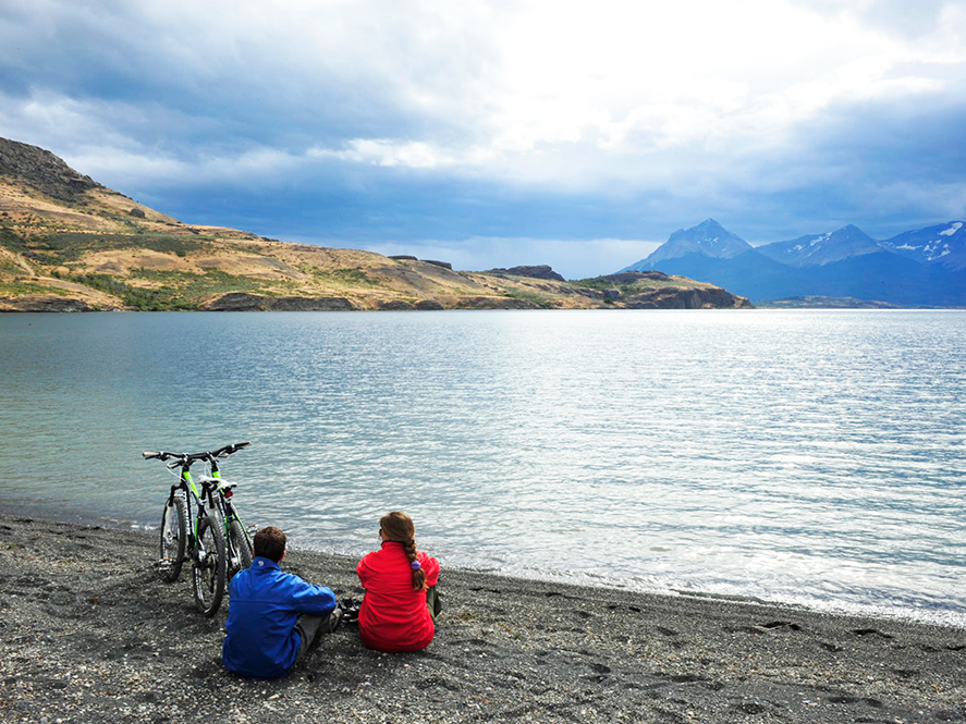A couple sitting at the coast near The Singular Patagonia