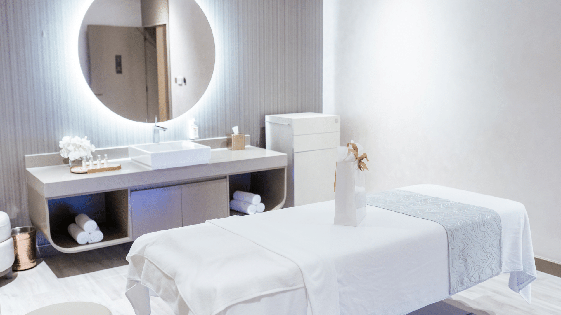 Bright and minimalist spa treatment room with a comfortable massage bed and a modern sink area at Paramount Hotel Midtown