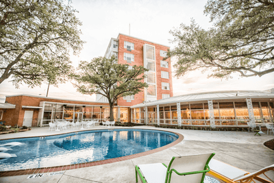 a pool outside of a hotel building