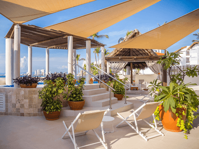Distant view of outdoor pool entrance with lounge chairs in Shakti Spa at Buenaventura Grand Hotel and Spa