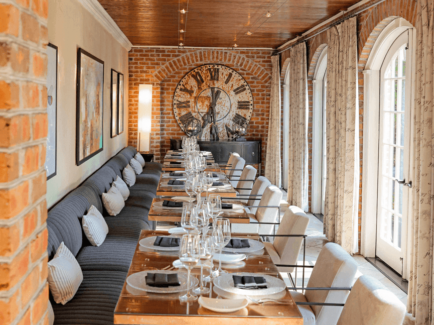 Chef's Table in Vintage Restaurant with Brick Walls and a Large Clock Decor at willow grove events, Inn at Willow Grove