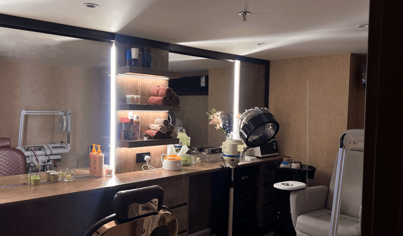 Salon station with a mirror by shelves, and a hair dryer at Warwick Al Jubail