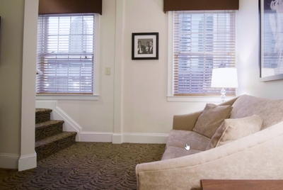 A couch in a living area of One Bedroom Suite at Artmore Hotel