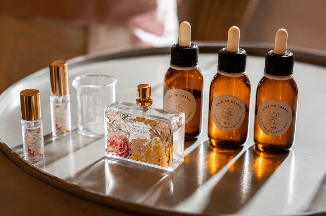 Luxury perfume and amber dropper bottles arranged on a silver tray at Hotel Westminster Warwick Paris