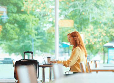 Woman working on laptop by a window at Rodd Hotels & Resorts, a top choice for places to stay in charlottetown