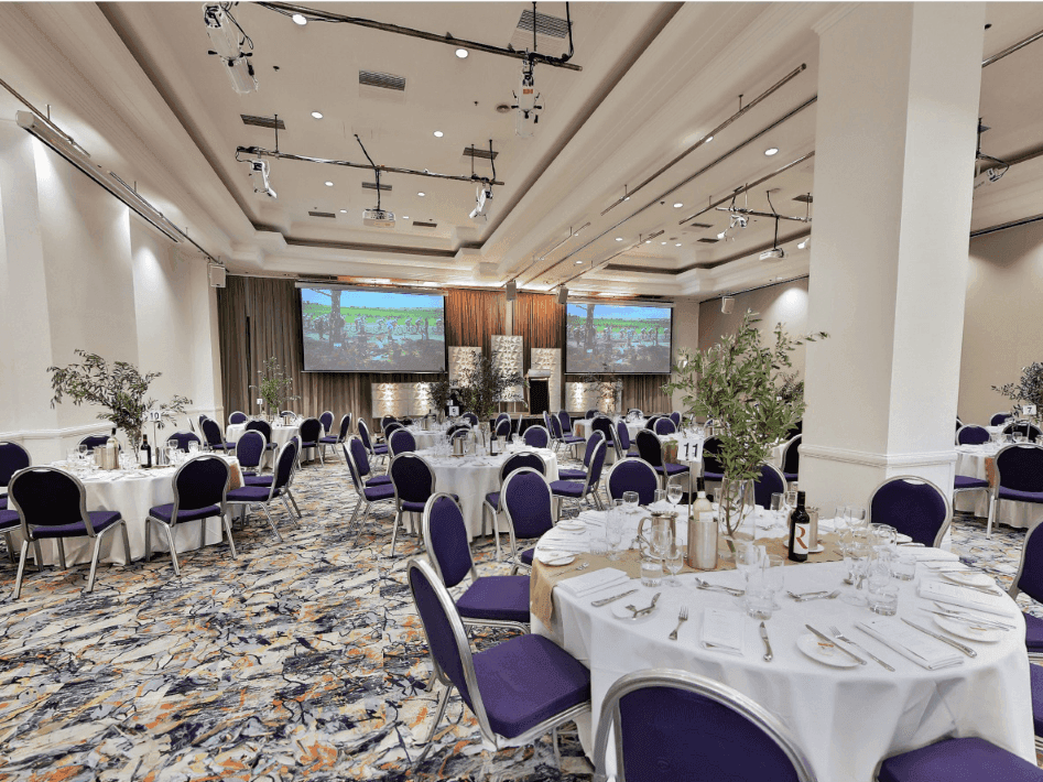 Elegantly set event room with round tables at Hotel Grand Chancellor Adelaide.
