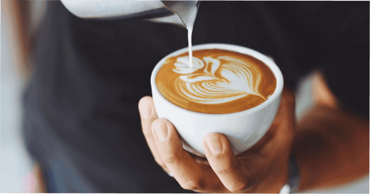 Close-up of a coffee being poured in a Townsville Café.