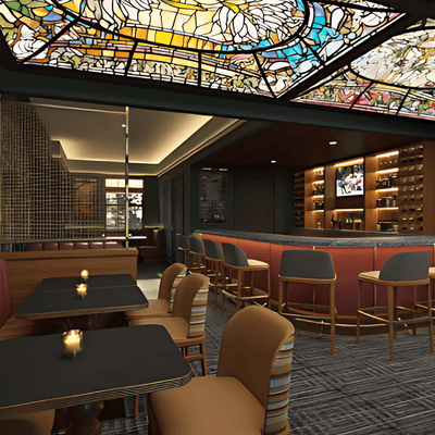 Dining tables near a curved bar with barstools under a stained-glass ceiling at La Tourelle Hotel and Spa