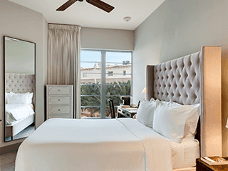room with large bed and tall windows