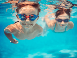 2 kids swimming underwater in pool at Jacobs Aquatic Center near Bayside Inn Key Largo
