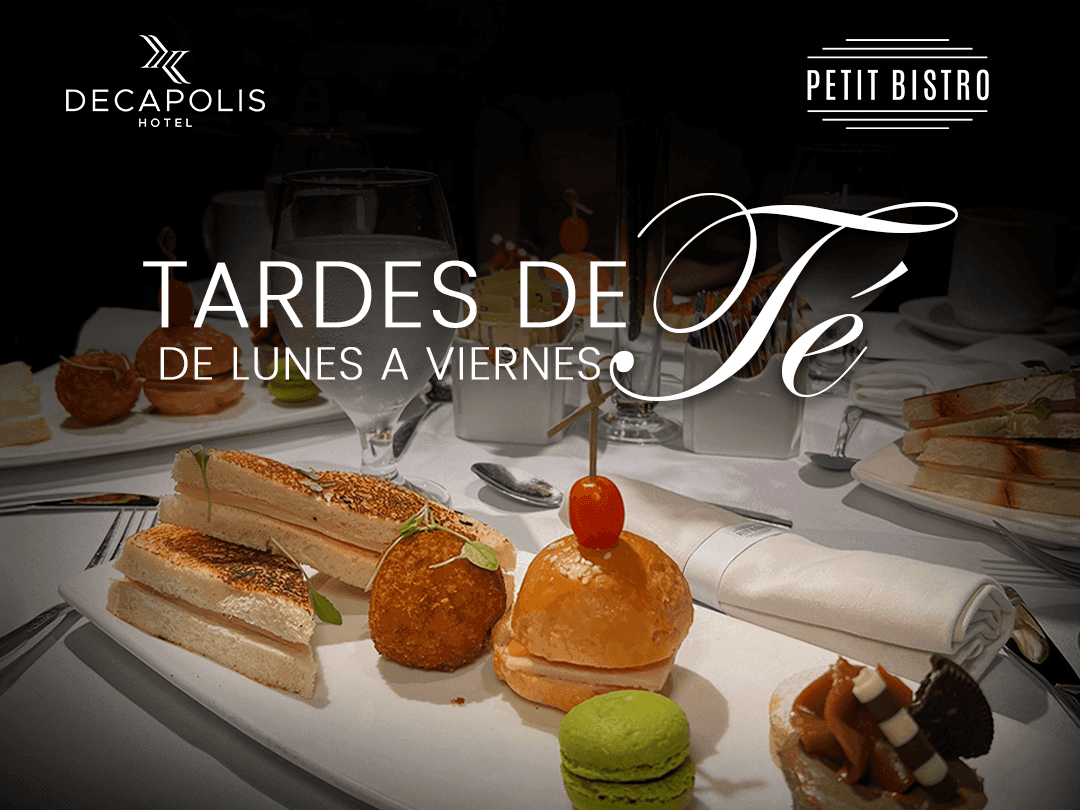 Plate of sandwiches, macaron, and dessert with 