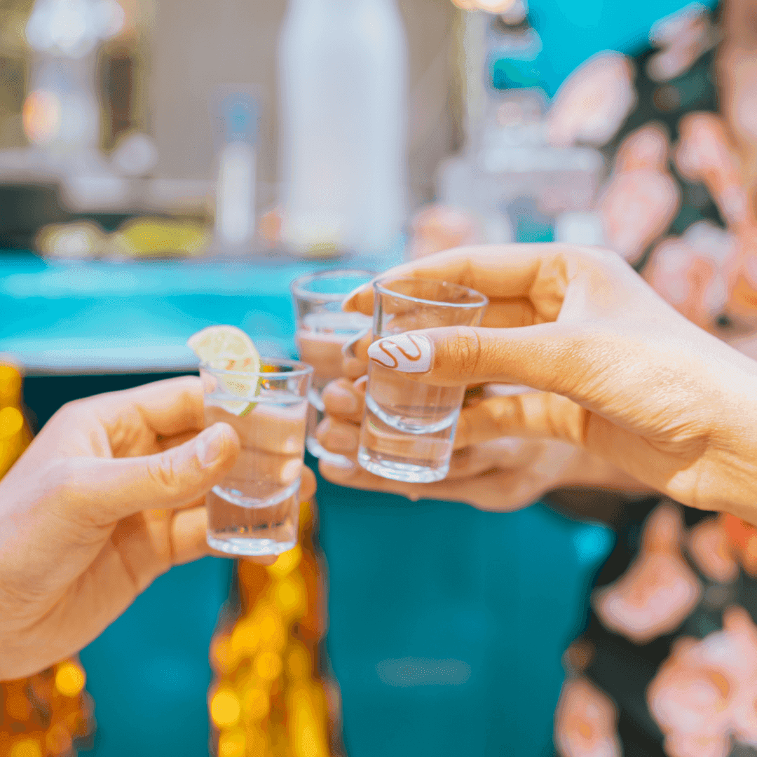 A group of friends cheerings shots of tequila