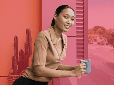 Woman holding a cup with Live Close, Live Easy text overlay at UniLodge Darwin.