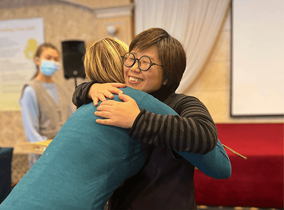 Two women hugging at Honor's Haven Retreat & Conference Retreat