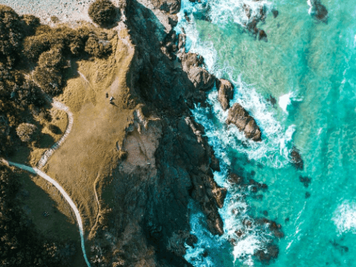 Aerial view of a pathway by the rocky coast near Pullman & Mercure Brisbane King George Square