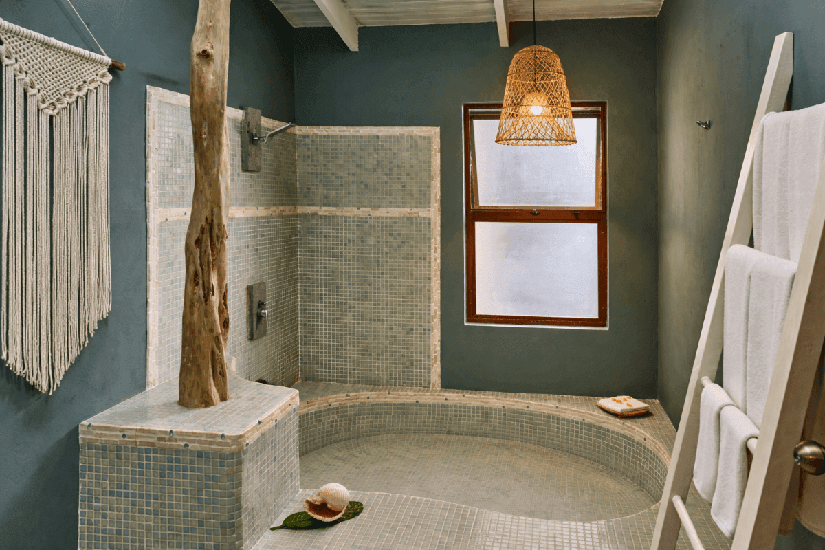 Interior of a bathroom with a large tub and window at Cala Luna Boutique Hotel