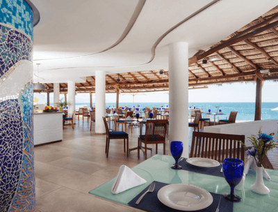 Arrangement of dining tables with ocean view in Sunset Restaurant at Buenaventura Grand Hotel and Spa