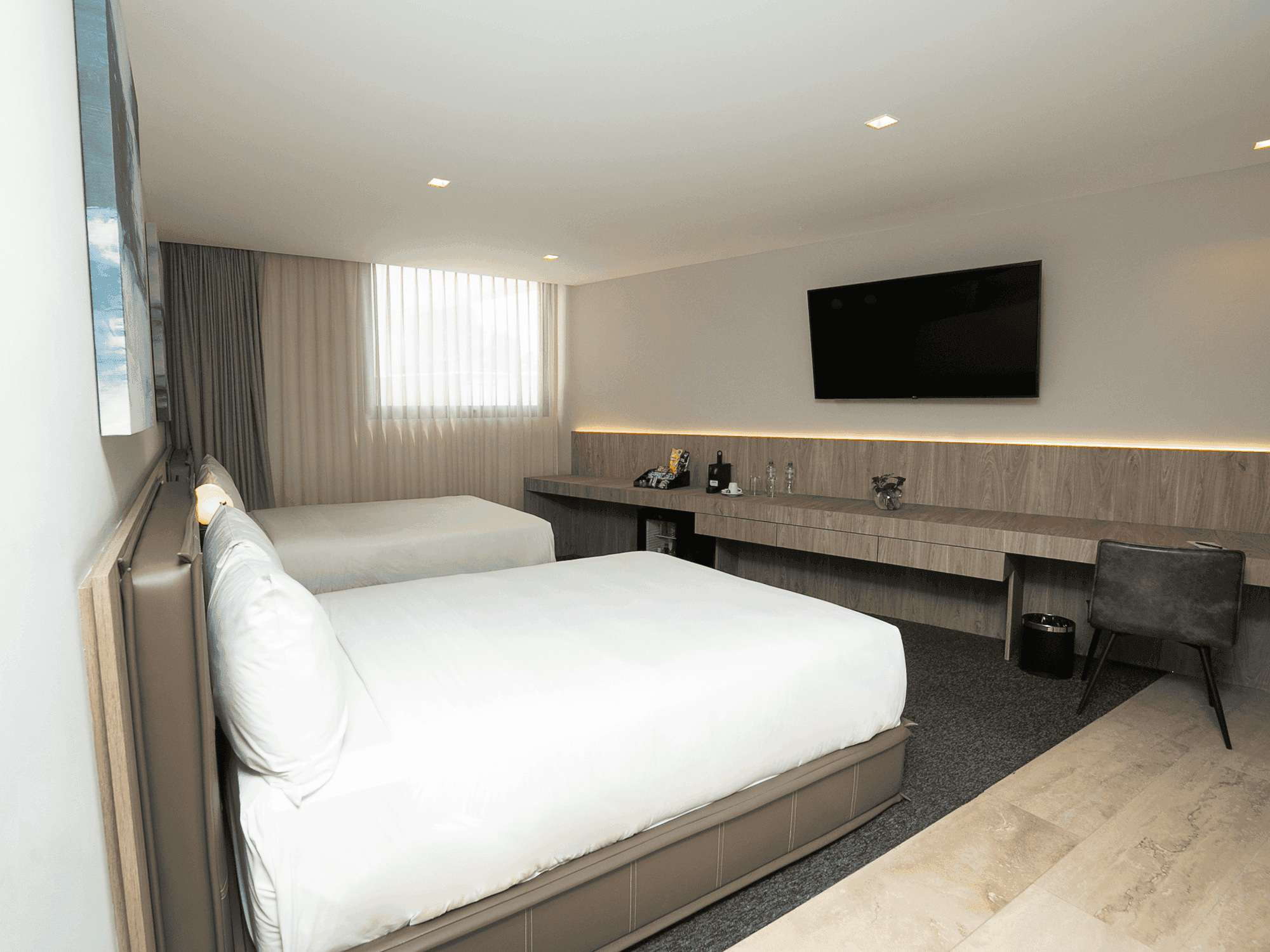 Habitación Deluxe Double con dos camas y televisor en Elements by Marquis, Ciudad de México.