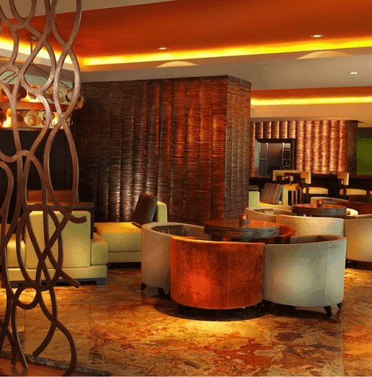 Ciao Tapas & Pizza Restaurant lounge with round tables and chairs by woven walls at Megapolis Hotel Panama