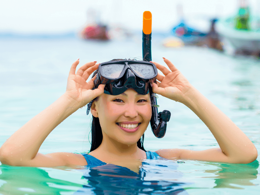 Swimmer with snorkeling glasses posing for a photo near Bayside Inn Key Largo