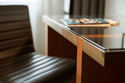 Sleek and functional work desk with a glossy top and a comfortable chair in Deluxe Queen Queen at Paramount Hotel Portland