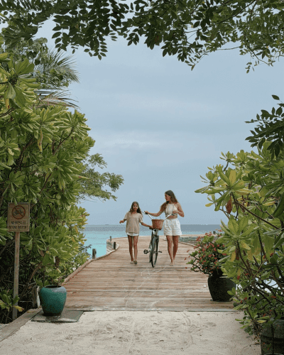 Grand Park Kodhipparu Maldives family riding a bicycle on the jetty