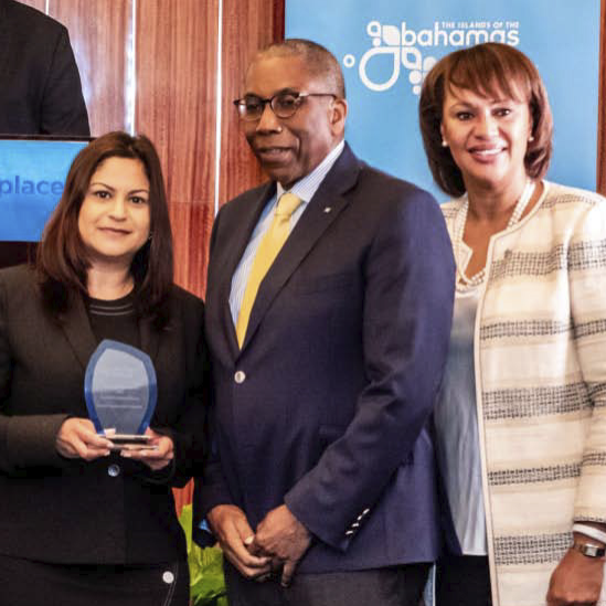 Portrait of hotel staff posing with Traveller's Award at Warwick Paradise Island Bahamas
